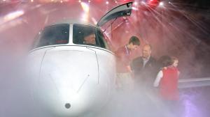 Joe Whisenhunt, the first owner of a Cirrus Vision Jet, helps family members from the plane at Monday’s event to mark the delivery and the opening of Cirrus’ finishing center. Photo by Steve Kuchera.